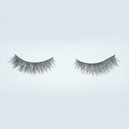 A pair of false eyelashes is shown on top of a white background.