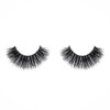 A pair of false eyelashes on top of white background.