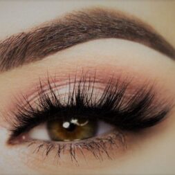 A close up of a person 's eye with long eyelashes
