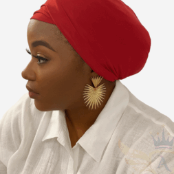 African American woman wearing a red versatile turban headwrap from Aloumbabelle, elegant and stylish, perfect for protective hairstyles and everyday wear.