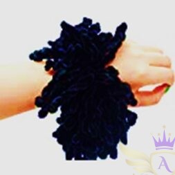 : Black volumizer scrunchie shown worn on wrist, demonstrating size and fullness.