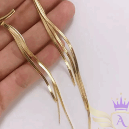 Hand holding gold long drop chain earrings with curved bar top