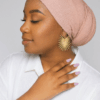 African American woman wearing a blush pink textured scarf, side profile pose.