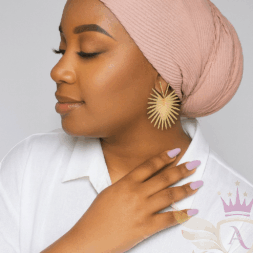African American woman wearing a blush pink textured scarf, side profile pose.