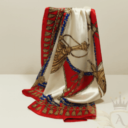 Luxury silk scarf with red, gold, and royal blue accents, draped to show elegant tassel and rope design.