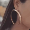 Woman wearing large gold hoop earring
