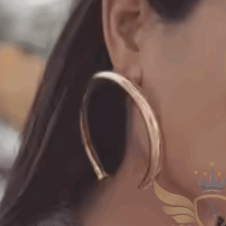 Woman wearing large gold hoop earring