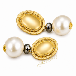 Close-up of luxe oval pearl drop earrings with gold oval top and pearl drop