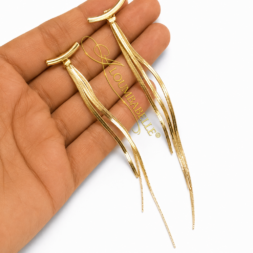 Hand holding gold long drop chain earrings with curved bar top