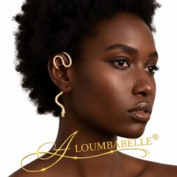 Black woman with a natural afro wearing gold snake-shaped ear jewelry in an Aloumbabelle beauty promotional image.